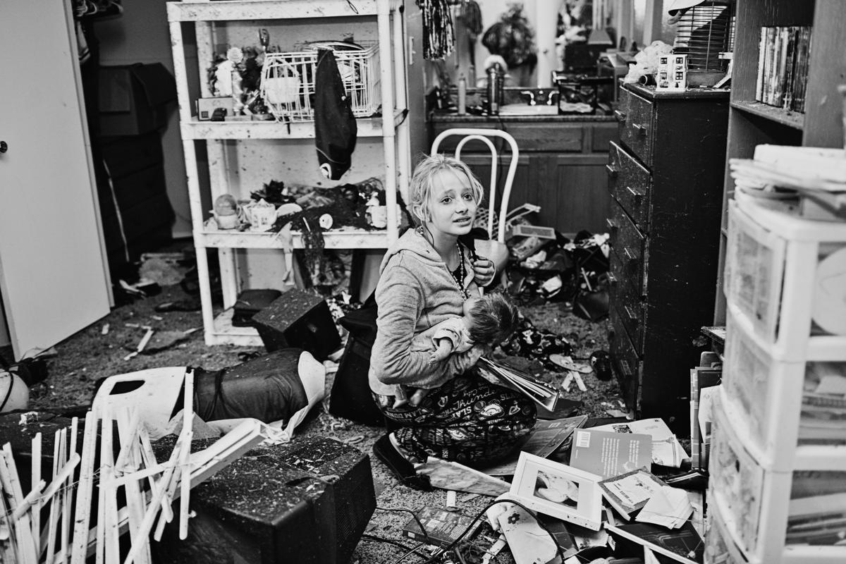 13.Melissa Golden's photograph of the scene after a tornado hit a residential house in Moore, Oklahoma, has been shortlisted in the Current Affairs category. In this picture Destiny Pierman, 13 collects belongings from the damaged bedroom of her home. She and her mother feared the house had been leveled and were relieved to find that, although it was damaged, it was still standing. Destiny's epilepsy medication, the family's primary concern, was right where they had left it. (Melissa Golden/Sony World Photography Awards)