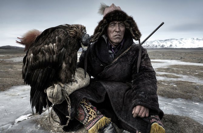 23.Above, a hunter rests on the plains (in) Western Mongolia with his eagle. (Simon Morris/2014 Sony World Photography Awards)