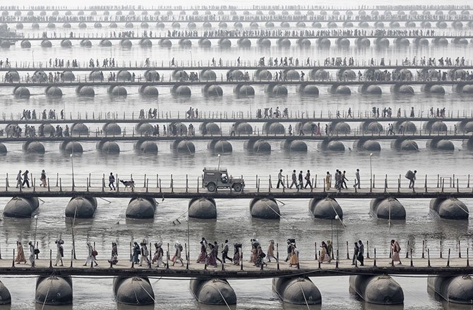 28.Hindu pilgrims and devotees of the Maha Kumbh Mela -- the largest spiritual gathering on the planet -- cross floating bridges. (Wolfgang Weinhardt/2014 Sony World Photography Awards)