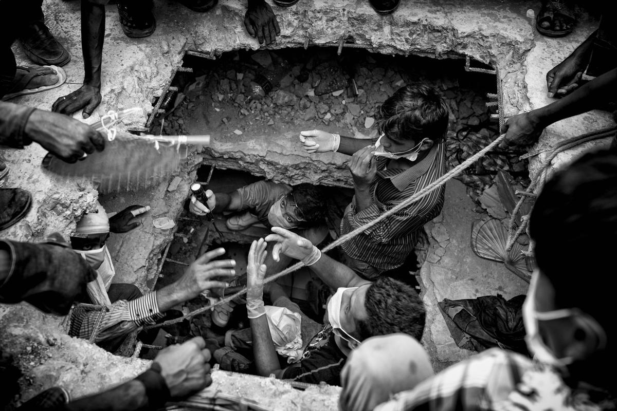 7.This picture of workers taking part in a rescue operation inside the eight‐story building Rana Plaza, which collapsed at Savar, outside Dhaka, Bangladesh, was taken by photographer K.M Asad and is one of a series shortlisted in the Current Affairs category. (K.M Asad/Sony World Photography Awards)