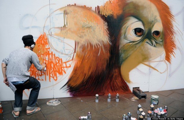 A graffiti artist puts the finishing touches to his painting for the See No Evil street art project in Nelson Street on August 20, 2011 in Bristol, England. The project is Europe's biggest street art festival and has attracted top graffiti artists from all over the world. Organisers hope it will become a major tourist attraction for Bristol, the spiritual home of Banksy.