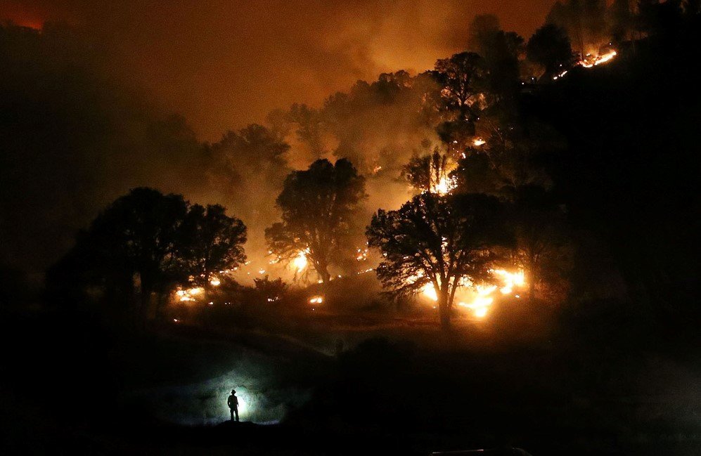 A California firefighter monitors a backfire while battling the Rocky Fire near Clearlake, California. The Rocky Fire burned more than 60,000 acres – Aug. 3, 2015