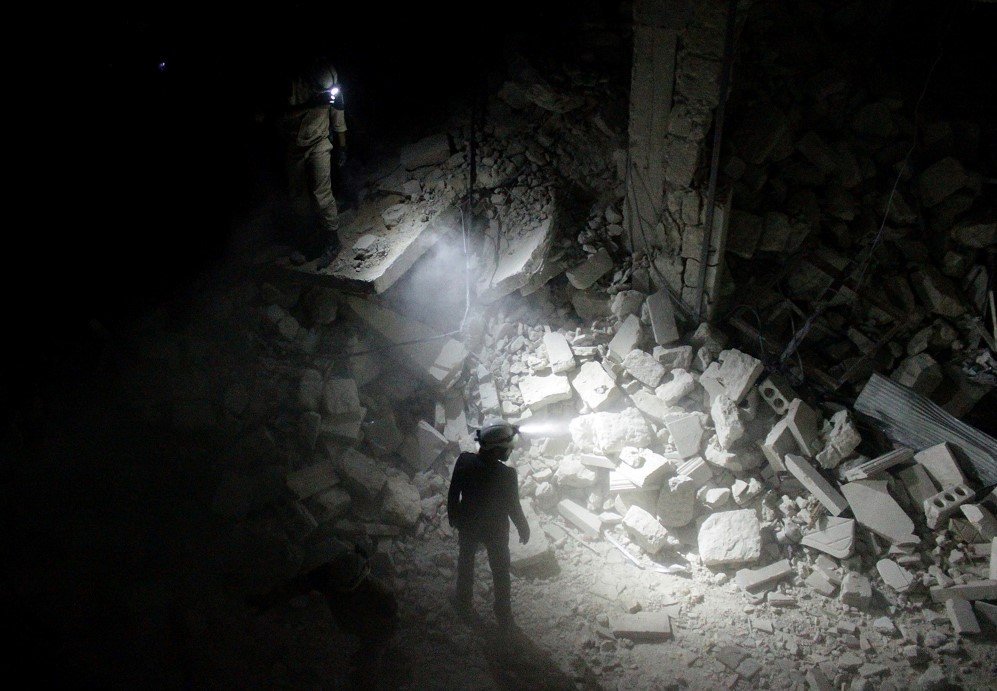 Search and rescue teams inspect collapsed buildings after Assad regime forces attacked a residential area in Aleppo, Syria – July 9, 2015.